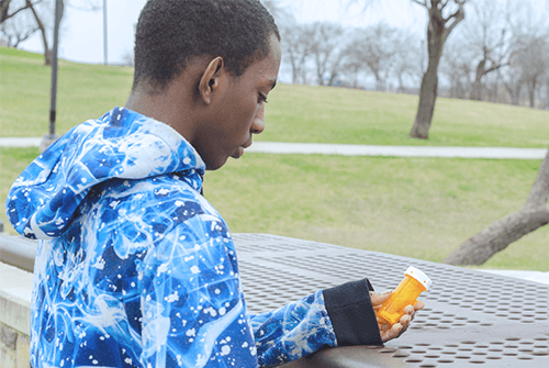 man holding pill bottle