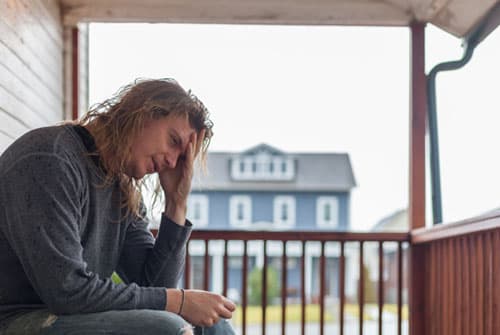 morphine user in distress sitting on porch