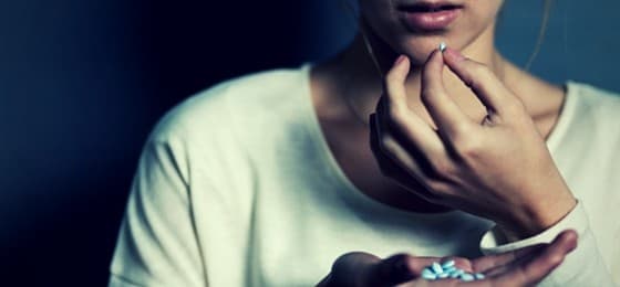 woman taking pills