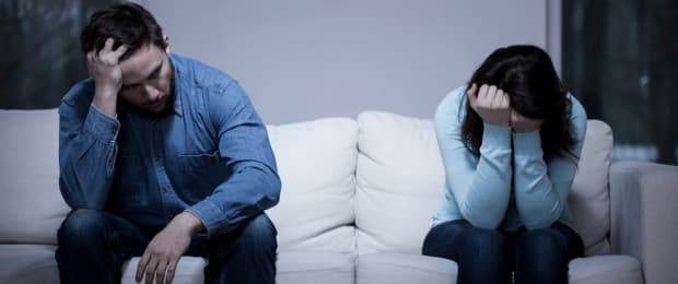 man and woman on couch dealing with addiction