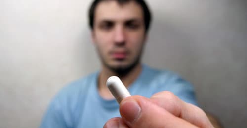 man holding pill