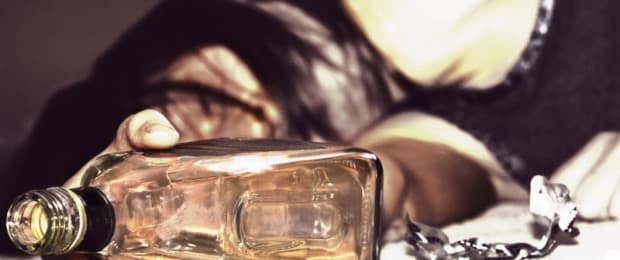 drunk woman with bottle of alcohol