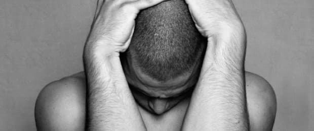 man with head in hands